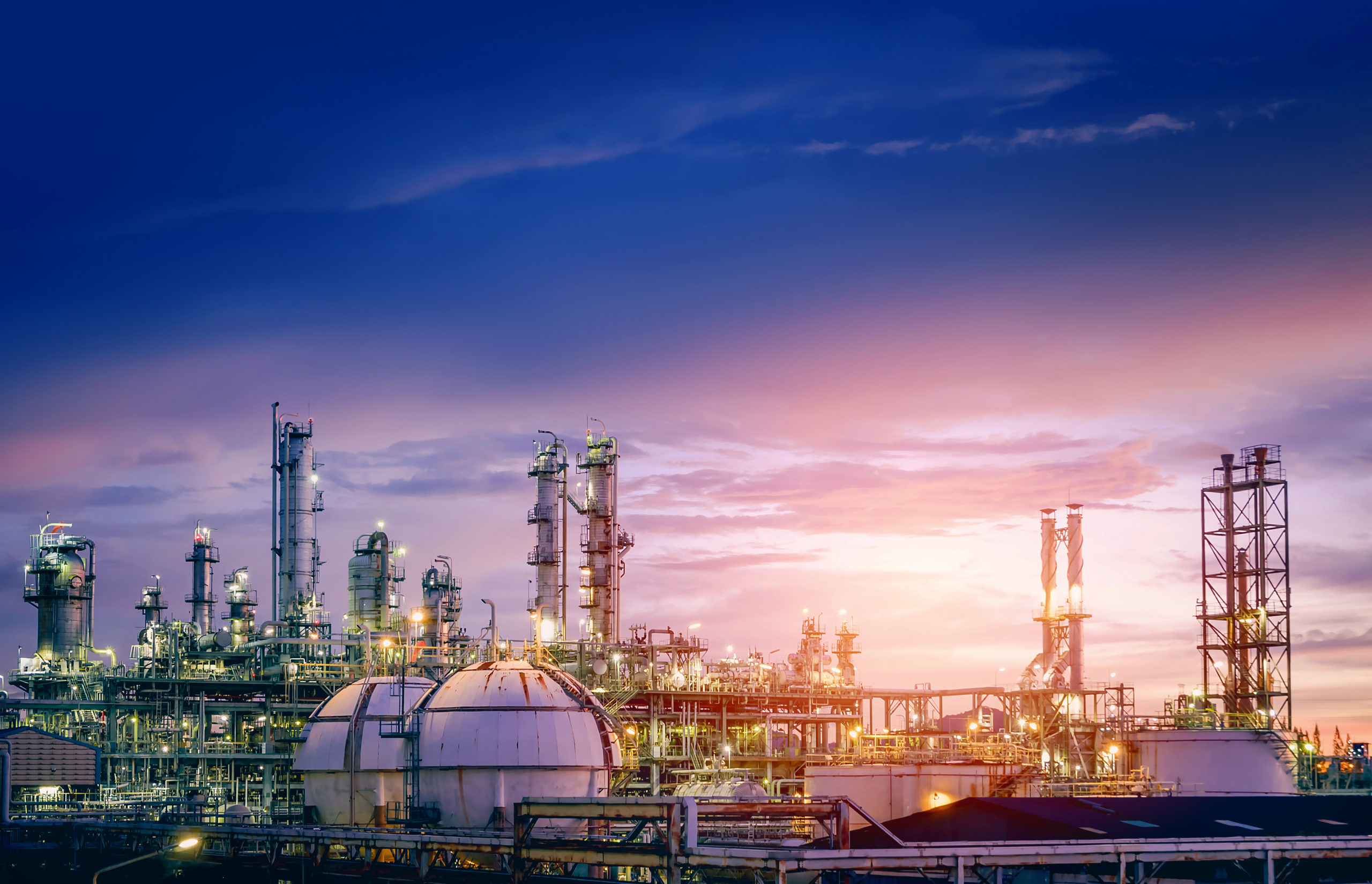 Oil and gas refinery plant or petrochemical industry on sky sunset background, Factory with evening, Manufacturing of petrochemical industrial natural gas